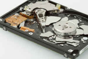 Broken hard drive disk. Macro, focused on magnetic head.